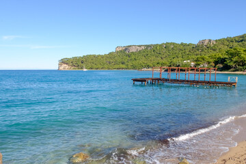 Dock is on the beach next to the water