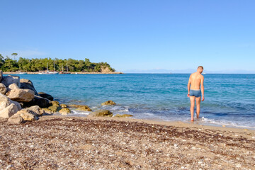 Man is standing on the beach