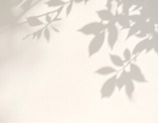 Soft, blurred shadows of leaves cast on a light-colored wall