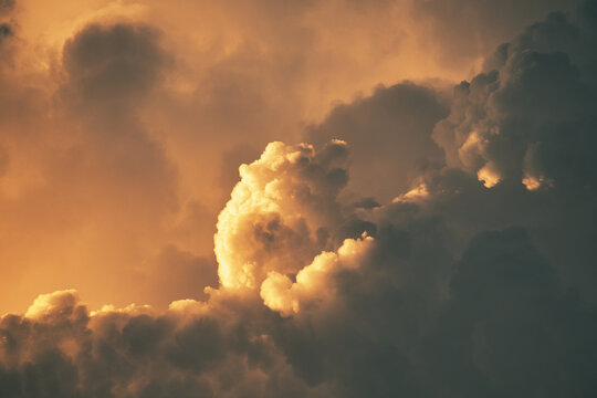 Dramatic sunset clouds with warm orange hues creating a fluffy and atmospheric scene - Powered by Adobe