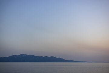 Sunset over the sea with silhouettes of islands. Adriatic Sea, Makarska Riviera, South Dalmatia, Croatia