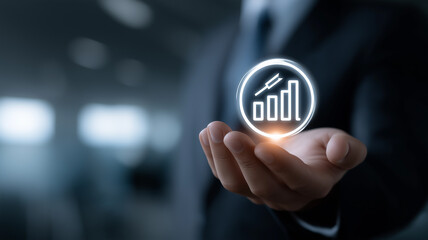 Business growth and success concept showing holographic bullseye with arrow hitting center and financial bar chart held by businessman in suit with corporate office background