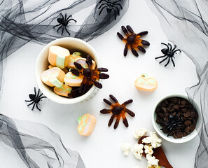 typical Halloween sweets in bowl and themed background with spider decorations