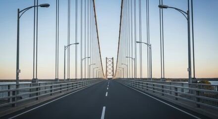 Obraz premium Symmetrical perspective of an empty suspension bridge under clear sky