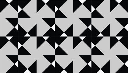 Abstract geometric seamless pattern with black and white triangular shapes forming a modern repetitive design on a gray background