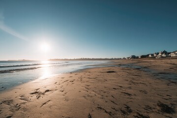 Sunny beach scene at sunrise.  Tranquil coastal view