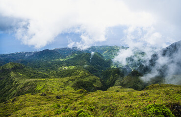 Majestic Mountains with Lush Greenery Veiled in Ethereal Mist and Clouds