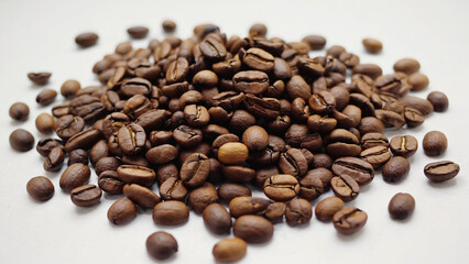 Pile of Brown Coffee Beans on White Background Surface