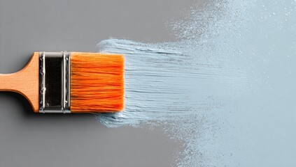 Paintbrush with light blue paint splatter