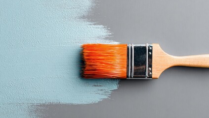 Light-blue paint being applied with a paintbrush