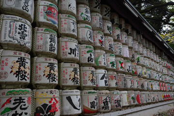 A vibrant wall of decorative sake barrels at Meiji Shrine, Tokyo. Offered as symbols of prosperity,...