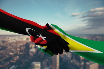 Shaking hands Libya and Guyana