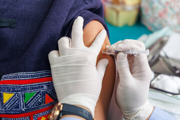 Get vaccinated against influenza. A Medical Professional Administering a Vaccine Shot to a Patient's Arm