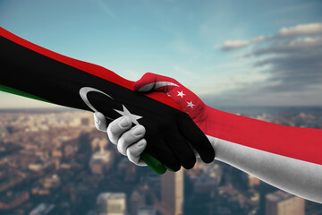 Shaking hands Libya and Singapore