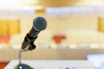 Fototapeta premium Microphone and Documents on a Podium in an Empty Conference Hall