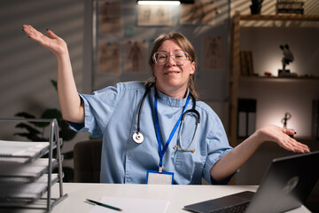 nurse working overtime on night say Sorry dont know make awkward smile in hospital office. Health care and medicine service