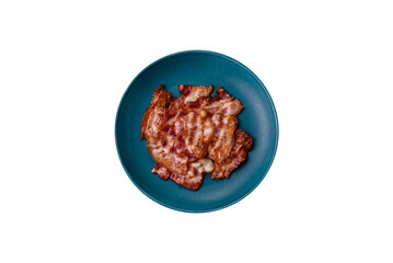 Cooked crispy fried pork bacon strips for a hearty breakfast. Fried bacon strips
