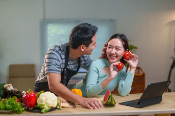 Young chefs joyfully preparing a healthy meal with fresh vegetables in a vibrant kitchen, sharing laughter and love for culinary arts