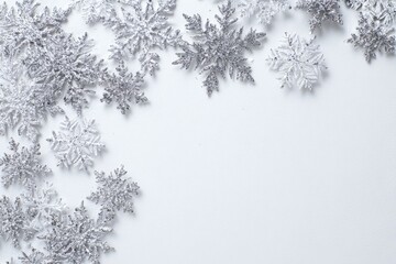 Silver snowflakes on white background