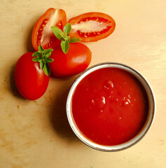 tomato sauce with fresh tamte and basil on wooden background