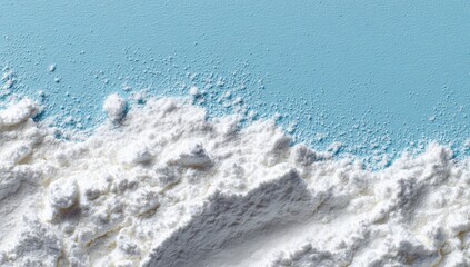 Close-up of a pile of flour against a light blue background