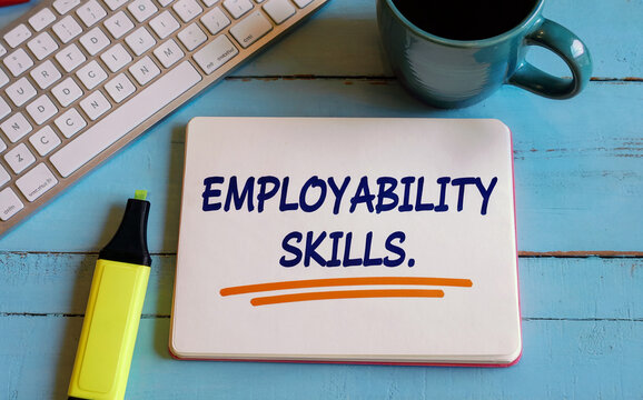 "EMPLOYABILITY SKILLS." text on a white board with keyboard, mug, and highlighter, symbolizing career development and professional training.