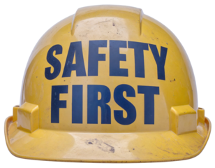 Yellow construction hard hat with bold "SAFETY FIRST" lettering across the front.
