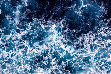 Ocean water background. Top view of stunning foamy water. Can be used in covers, packaging, posters, textures, wallpapers, art and design projects. Awesome nature background image.
