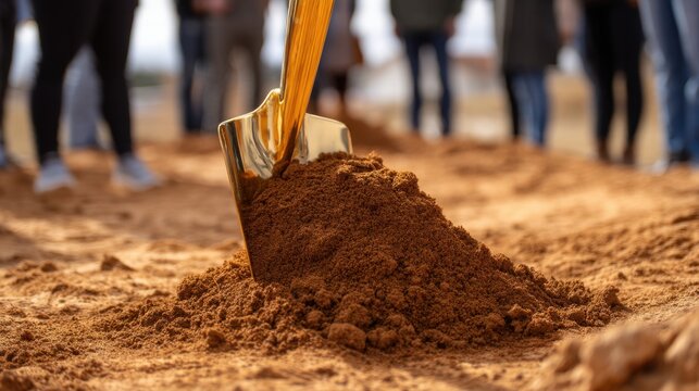 Golden shovel in dirt heap at a ground breaking ceremony, signifying new construction and development project. - Powered by Adobe