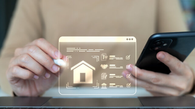 Businesswoman using a smartphone and digital interface for a real estate transaction, online property purchase, smart home investment, and modern housing technology concept.