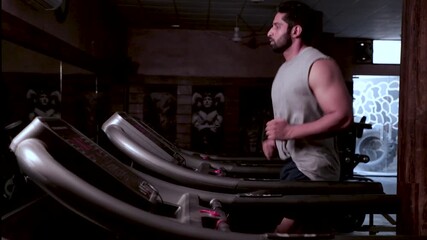 Indian Man Running on Treadmill in Gym for Fitness