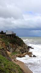 Coastal landscape with a small building on a cliff