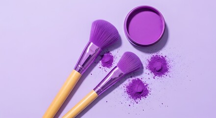 Two vivid purple makeup brushes with scattered pigment powder