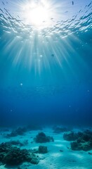 Sunlight streams through clear ocean waters to sandy seabed landscape