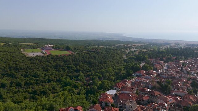 Aerial Drone Shot Over Litochoro Town Towards The Coast And Sea, Pieria, Greece, Early Summer Morning