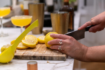 close-up Preparing Fresh Margarita Cocktail with Lemons on a Cutting Board in a Modern Kitchen