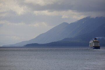 Modern cruiseship or cruise ship liner Solstice, Eclipse or Equinox departure sail away from Ketchikan, Alaska towards Inside Passage during Last Frontier adventure cruising
