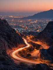 zigzag mountain road features car light trails at dusk in al hada taif saudi arabia illuminated city lights glow below rocky landscape as vehicles create streaks of light on winding highway