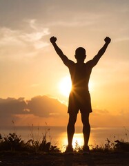Fototapeta premium Silhouette of a man triumphantly raising fists against a vibrant sunset backdrop feeling of victory