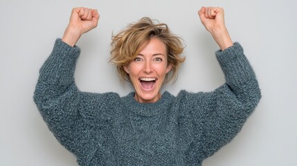beautiful middle age woman wearing winter sweater over isolated background excited for success with arms raised celebrating victory smiling winner concept no logos no brands ar 169
