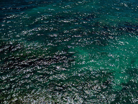 Glittering ocean water rippled surface.