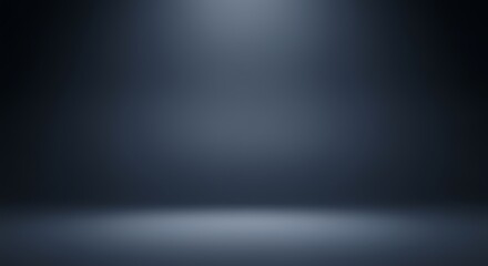 A dark, empty studio with a subtle spotlight illuminating the floor, creating a moody and atmospheric backdrop.