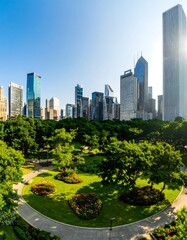 Fototapeta premium Lush parkland meets a vibrant cityscape, showcasing a tranquil urban oasis under a brilliant blue sky.