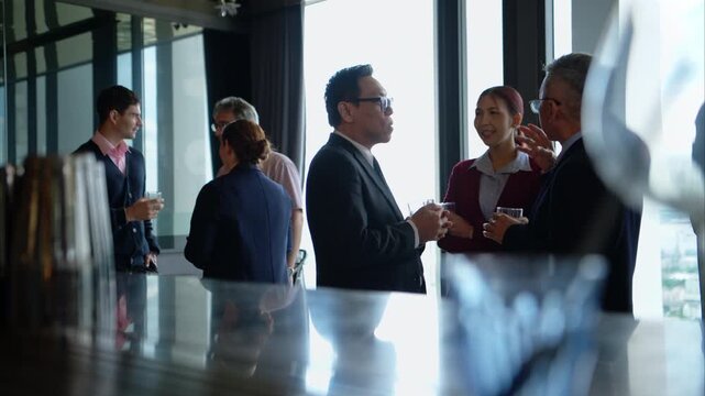 Business professionals networking and enjoying drinks at a corporate event in a modern office setting