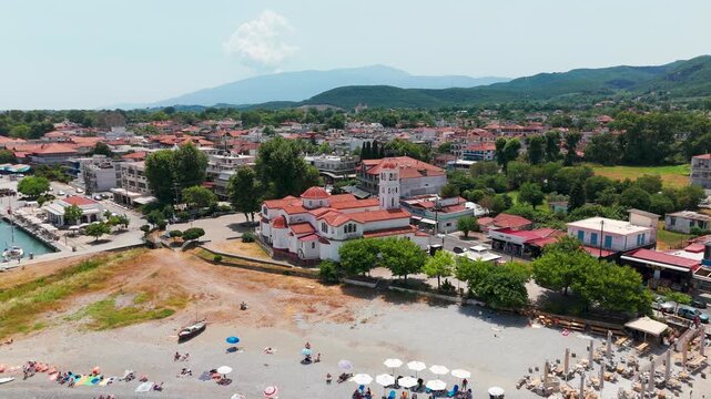 Aerial Drone Pan Out From Orthodox Church Towards Platamon Coastal Town And Aegean Sea In Pieria, Greece On A Sunny Summer Afternoon.