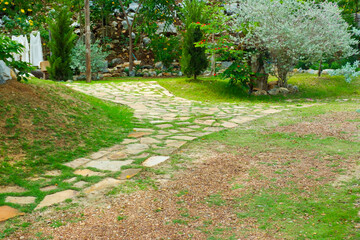 Garden landscape design with pathway in garden and footpath in picturesque summer park and staircase in backyard,Paving stones on floor in park,space for text.