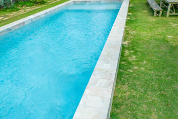 Empty swimming pool with sunbed and white umbrella in resort hotel for vacation leisure and white sand,resort neary sea and beach in summer.