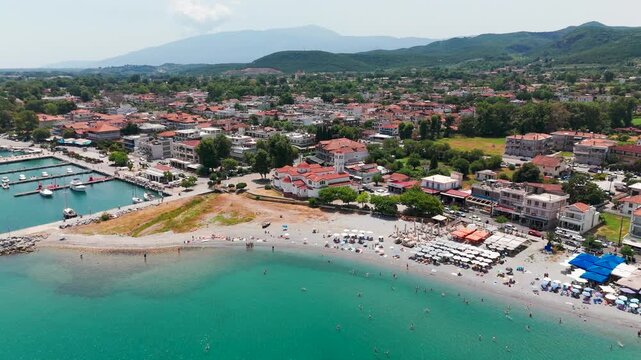 Aerial Drone Shot Flying Towards Platamon Coastal Town Over Turquoise Aegean Sea In Pieria, Central Macedonia, Greece On A Sunny Summer Afternoon.