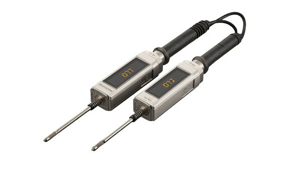 Two gray, rectangular devices with digital displays and probes, connected by a cable