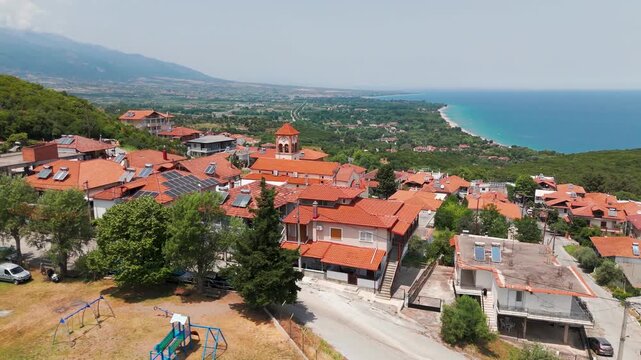 Aerial Drone Shot Circling Greek Orthodox Saint Eleutherius Church In Platamon, Greece On A Sunny Summer Afternoon.